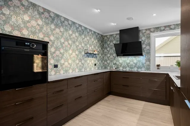Cabinet making service in the Dubai featuring custom built wooden kitchen cabinets with modern finishes, integrated appliances, and precise craftsmanship for functional storage