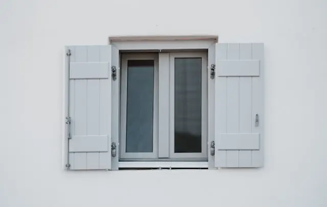 Custom joinery service in the Dubai featuring a handcrafted wooden window frame with shutters, precise fittings, and clean modern exterior finish
